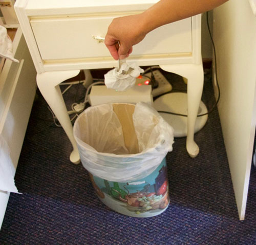Goves being thrown into a bin